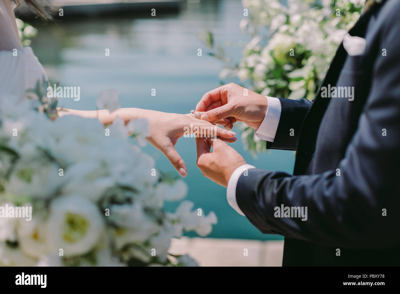 groom wearing wedding ring. Ring finger Stock Photo Alamy