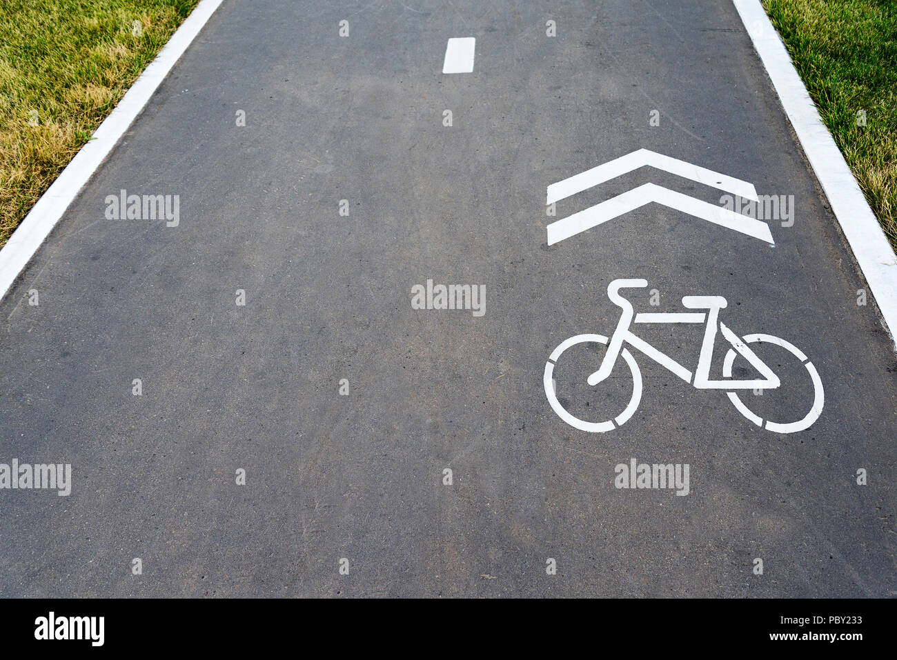 The Bicycle icon is painted on the asphalt with white paint Stock Photo ...