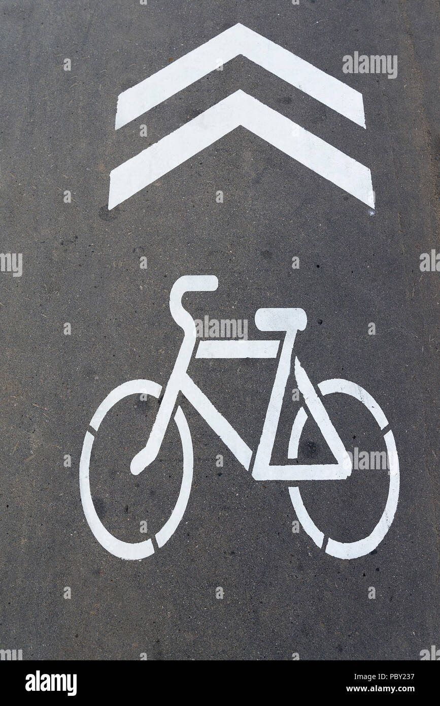 The Bicycle icon is painted on the asphalt with white paint Stock Photo ...