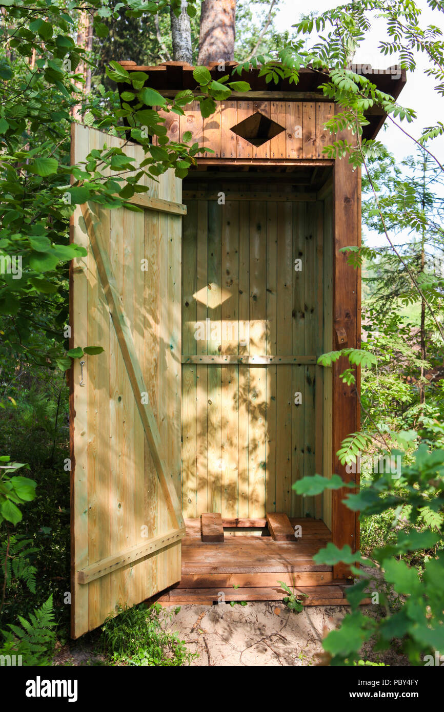 Wooden outdoors toilet in the forest, with open door Stock Photo - Alamy