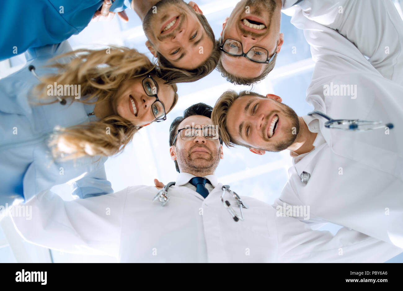 doctors looking down smiling at the camera Stock Photo - Alamy