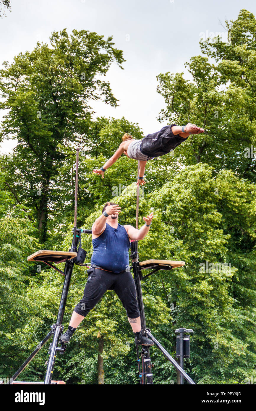 Male and female trapeze artists at the 'Fair in the Square', an annual festival in Pond Square and South Grove, Highgate Village, London, UK Stock Photo