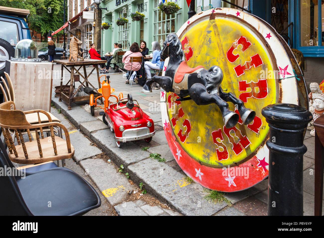 Retro bric-a-brac, toys and furniture outside a shop in Highgate Village, London, UK Stock Photo