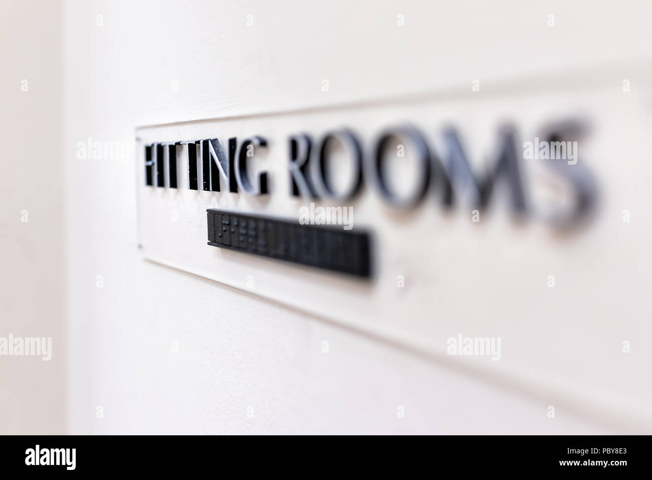 Closeup of Fitting Room sign in mall store shop retail clothing changing door entrance with nobody on wall, braille Stock Photo