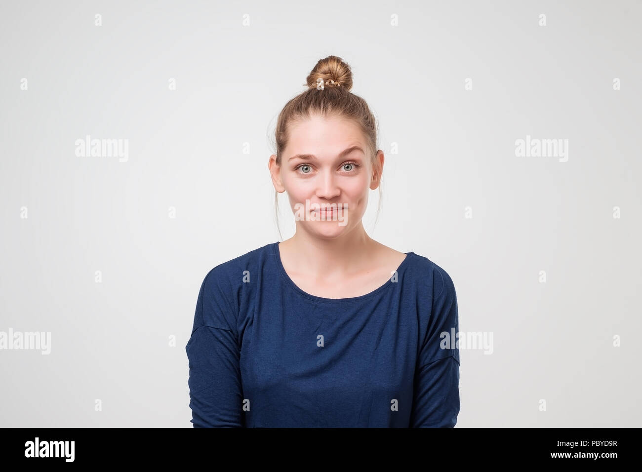 Tell me more. Close up shot of curious caucasian woman looking at camera with anticipation and excitement Stock Photo