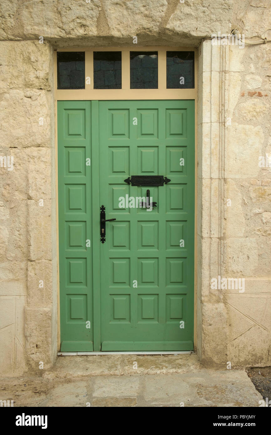 Decorative green painted street door on a town house in Tournon d'Agenais, Lot et Garonne, France Stock Photo