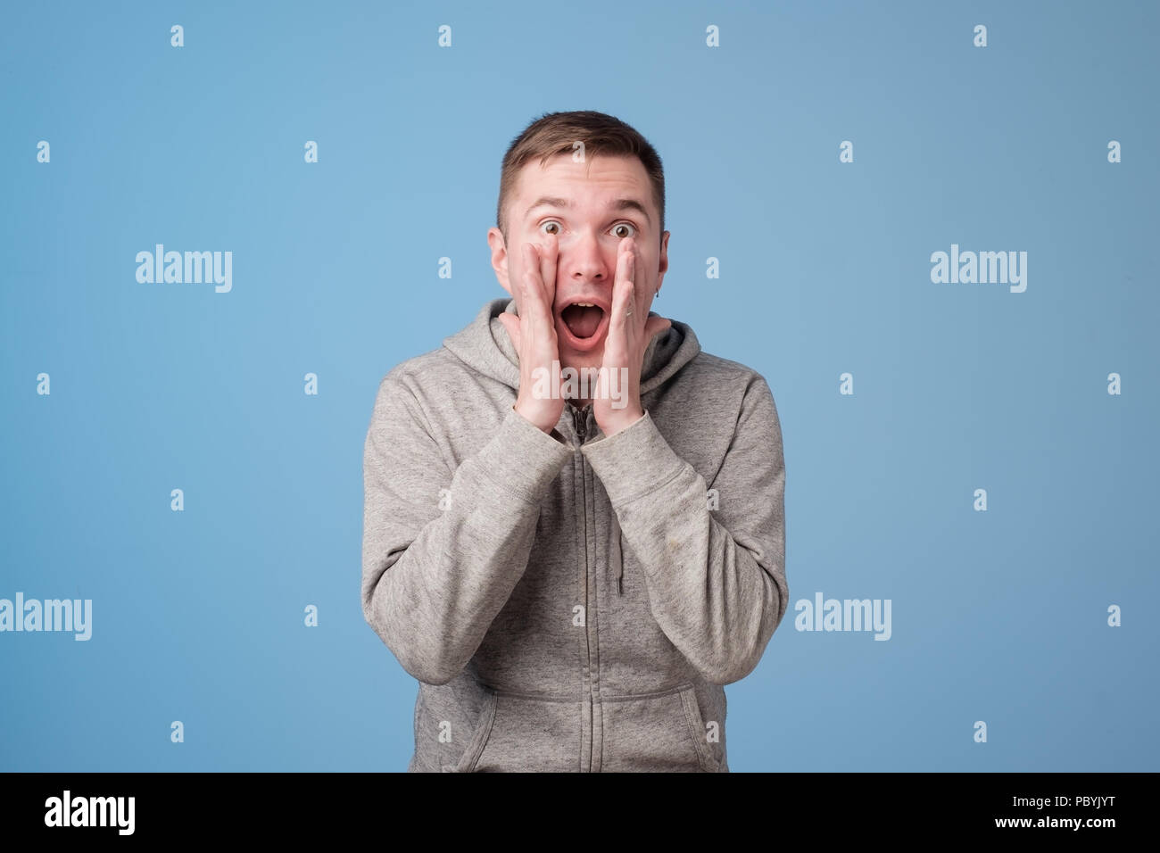 portrait of excited european man openinig mouth and shouting Stock Photo