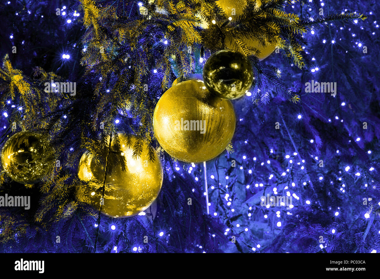 Christmas tree decorated with gold balls and garlands, toned background