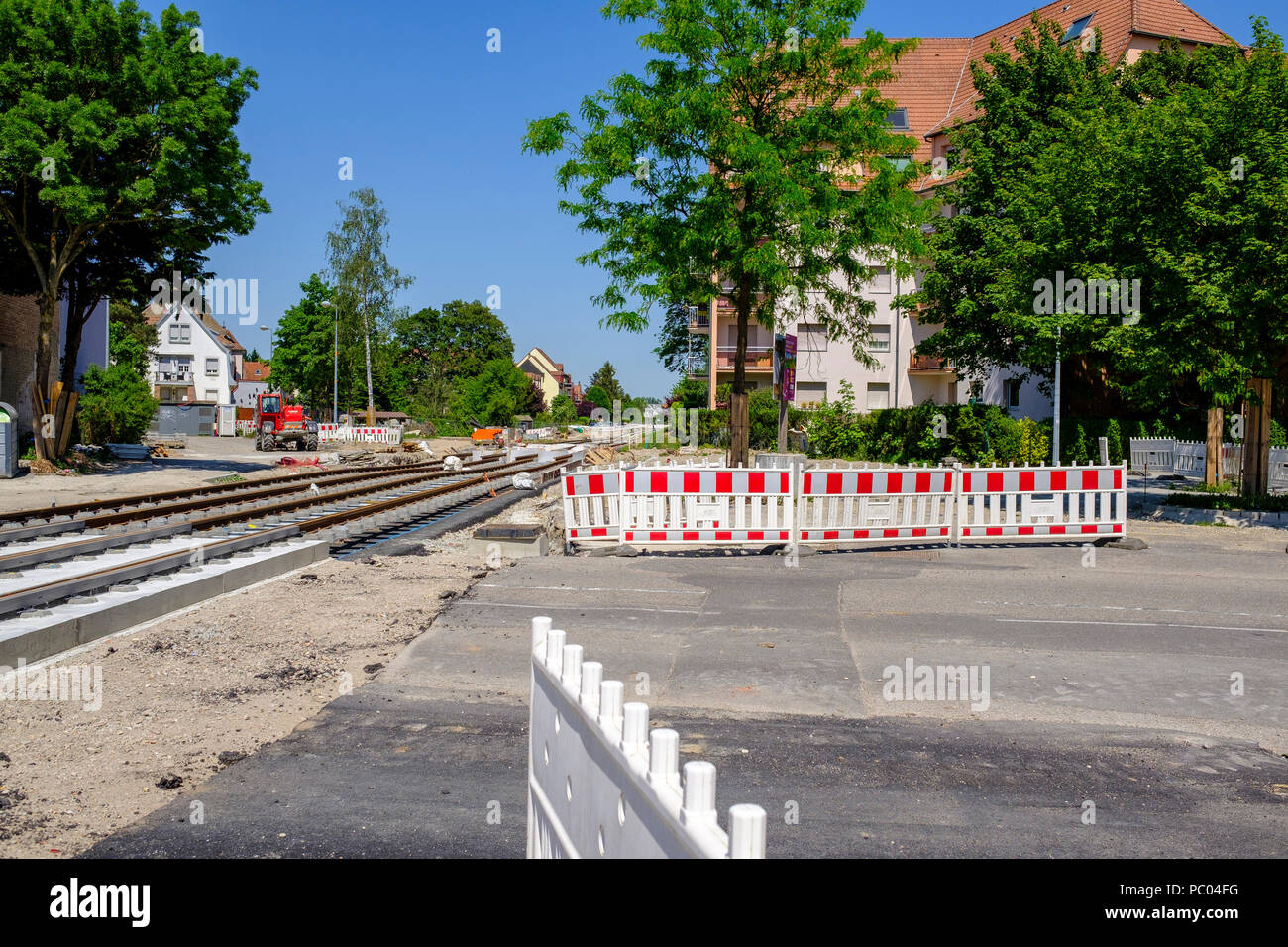 Strasbourg, tram construction site, railway tracks, concrete bed, safety plastic barriers, houses, line E extension, Alsace, France, Europe, Stock Photo