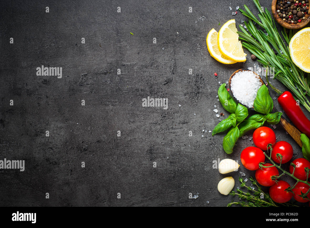 Food cooking background on black stone table Stock Photo - Alamy