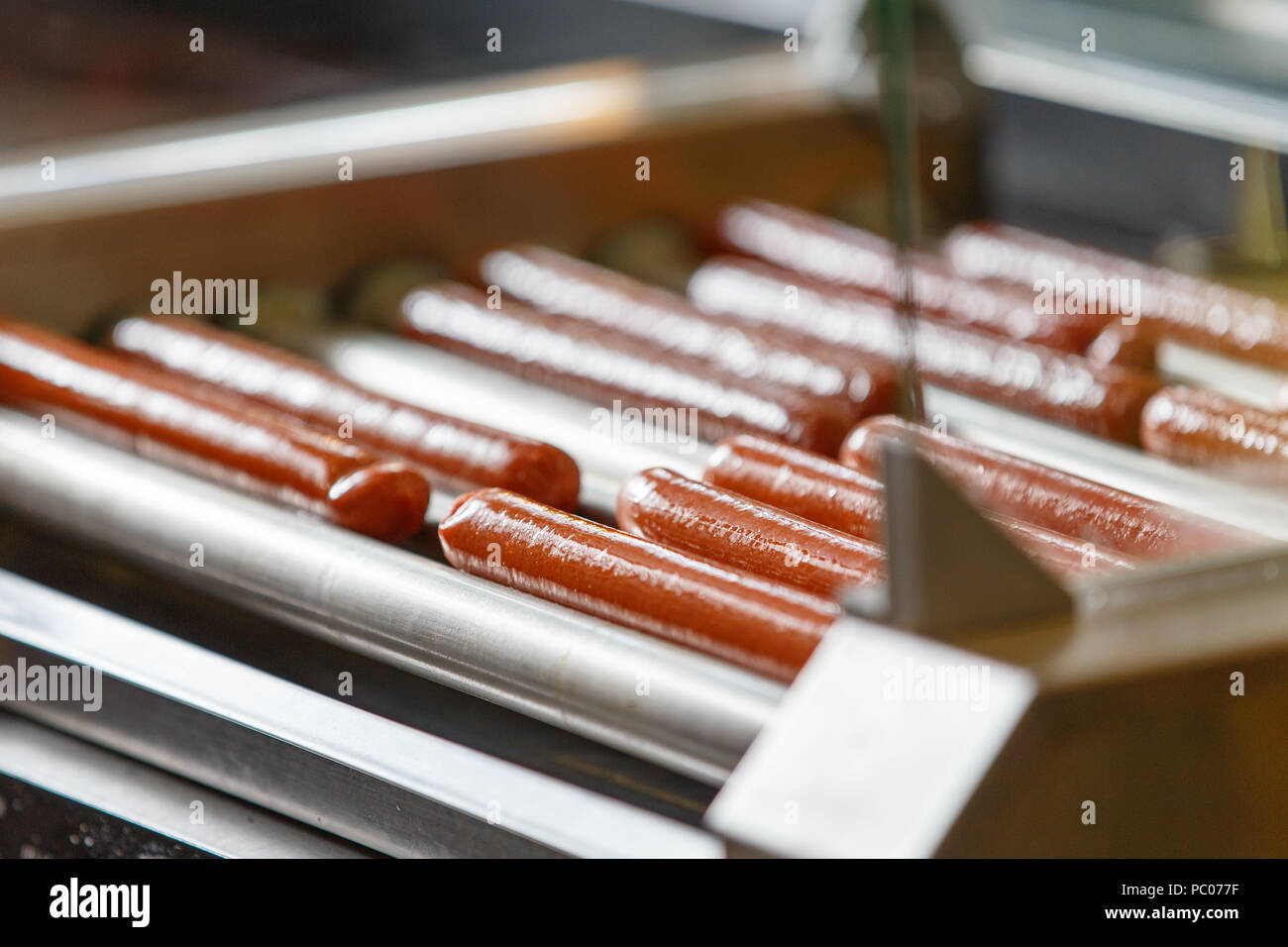 Greasy Hot dog sausages on turning cooking machine Stock Photo Alamy