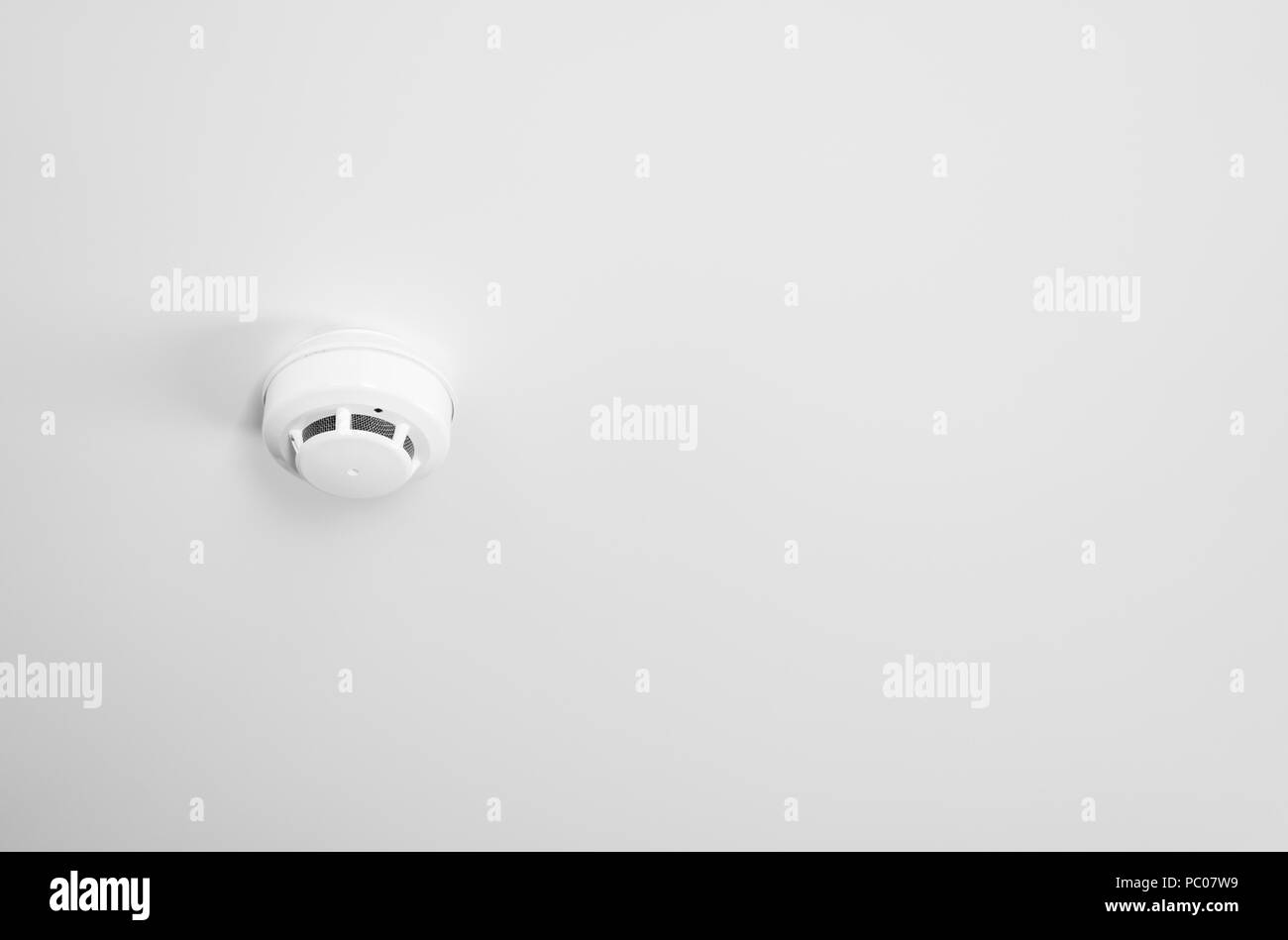 Smoke detector and pendent fire sprinkler on a ceiling Stock Photo