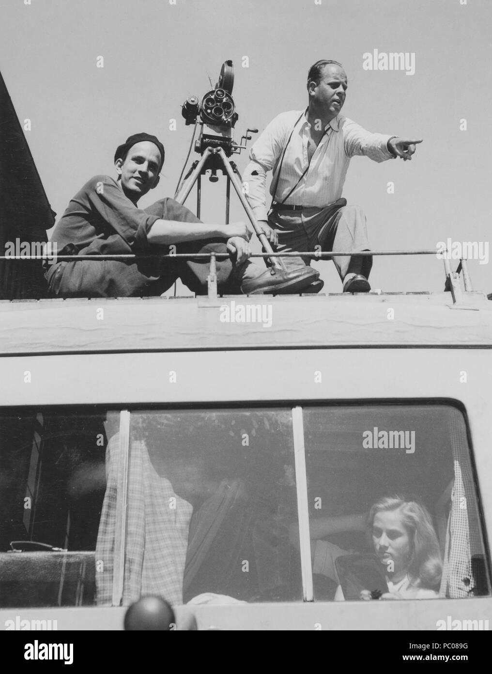 Ingmar Bergman. 1918-2007.  Swedish film director. Pictured here during the filming of the movie The Crisis. On the top of the bus roof, film photographer Gösta Roosling has set up his camera. Actress Inga landgré is behind the bus window. Stock Photo