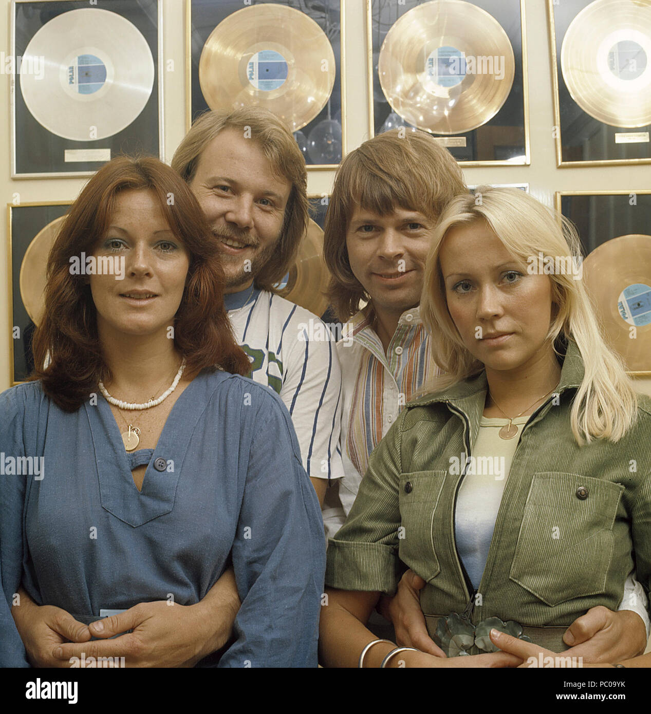 ABBA. Anni-Frid Lyngstad, Benny Andersson, Agnetha Fältskog and Björn Ulvaeus in the 1970s in front of a wall full of gold records for record selling albums. Stock Photo