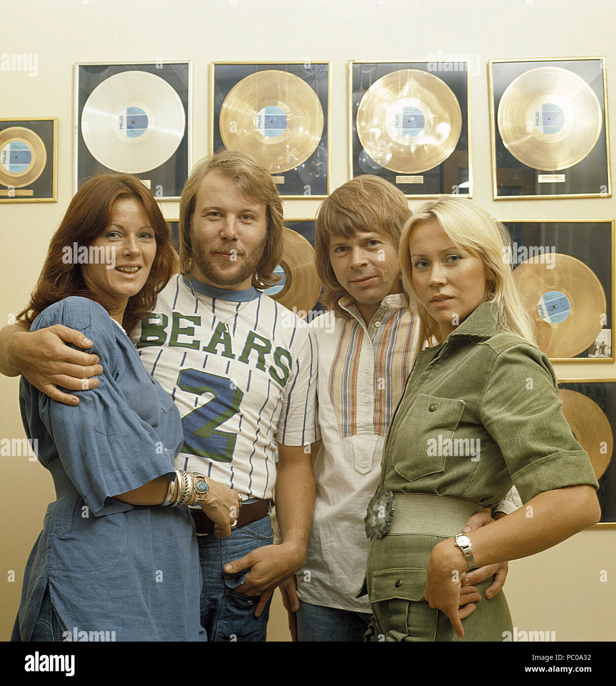 ABBA. Anni-Frid Lyngstad, Benny Andersson, Agnetha Fältskog and Björn Ulvaeus in the 1970s in front of a wall full of gold records for record selling albums. Stock Photo