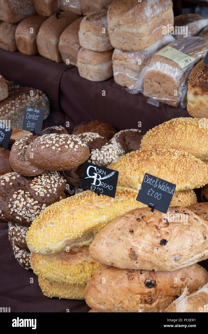 Artisan bread for sale on a stall at a farmers market. Deddington, Oxfordshire, England Stock Photo