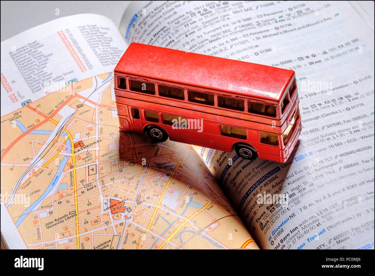 Miniature English red routemaster double decker bus on Michelin red guide, Stock Photo