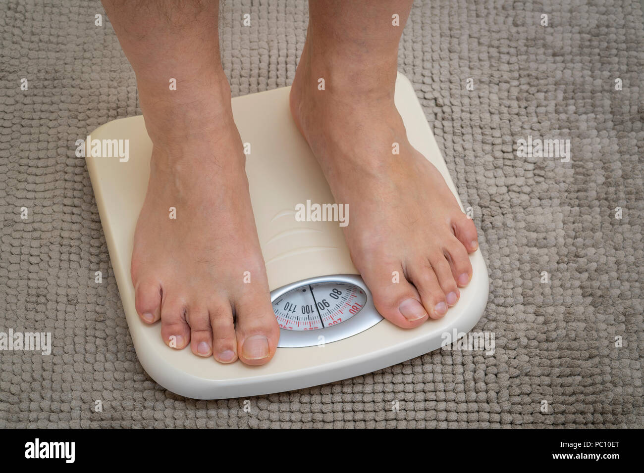 Obesity And Weightloss. Feet On Weight Scale. Pounds Stock Photo - Alamy