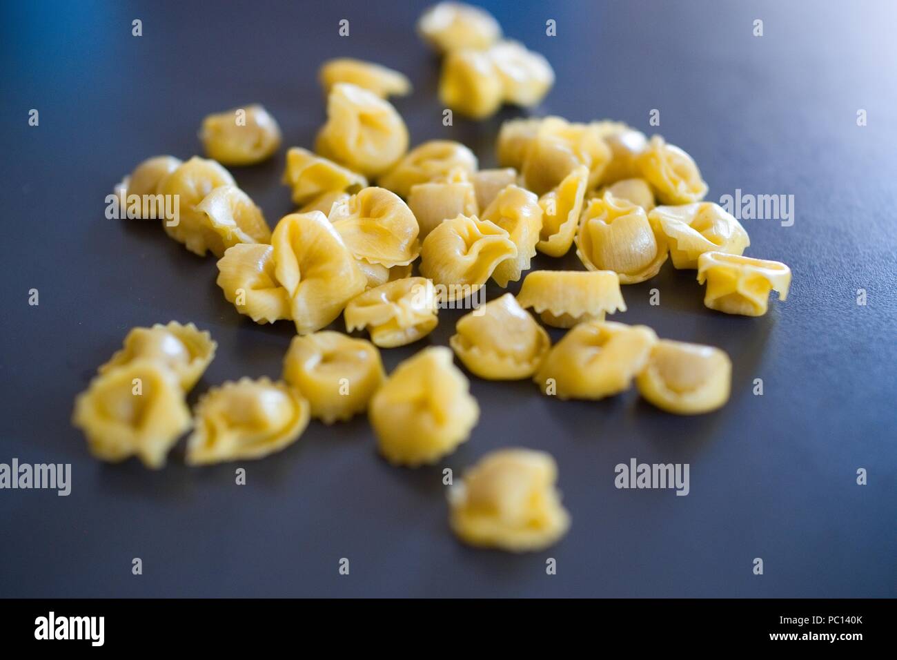 Tortellini, typical pasta of Bologna, Italy, filled with meat and spices, which is cooked with broth, during the Christmas holidays Stock Photo