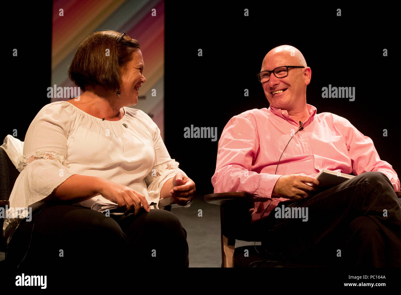 Sinn Fein President Mary Lou McDonald and leader of the PUP Billy Hutchinson share a moment during the Belfast Pride political debate at The Mac Theatre in Belfast to address a wide range of equality issues in Northern Ireland at part of the 2018 Belfast Pride Festival. Stock Photo
