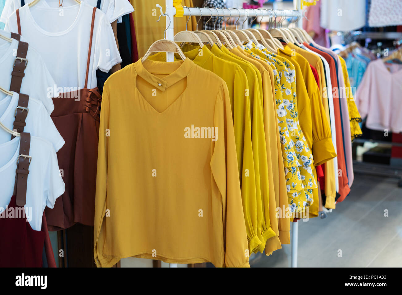 womens clothes on hangers in store Stock Photo