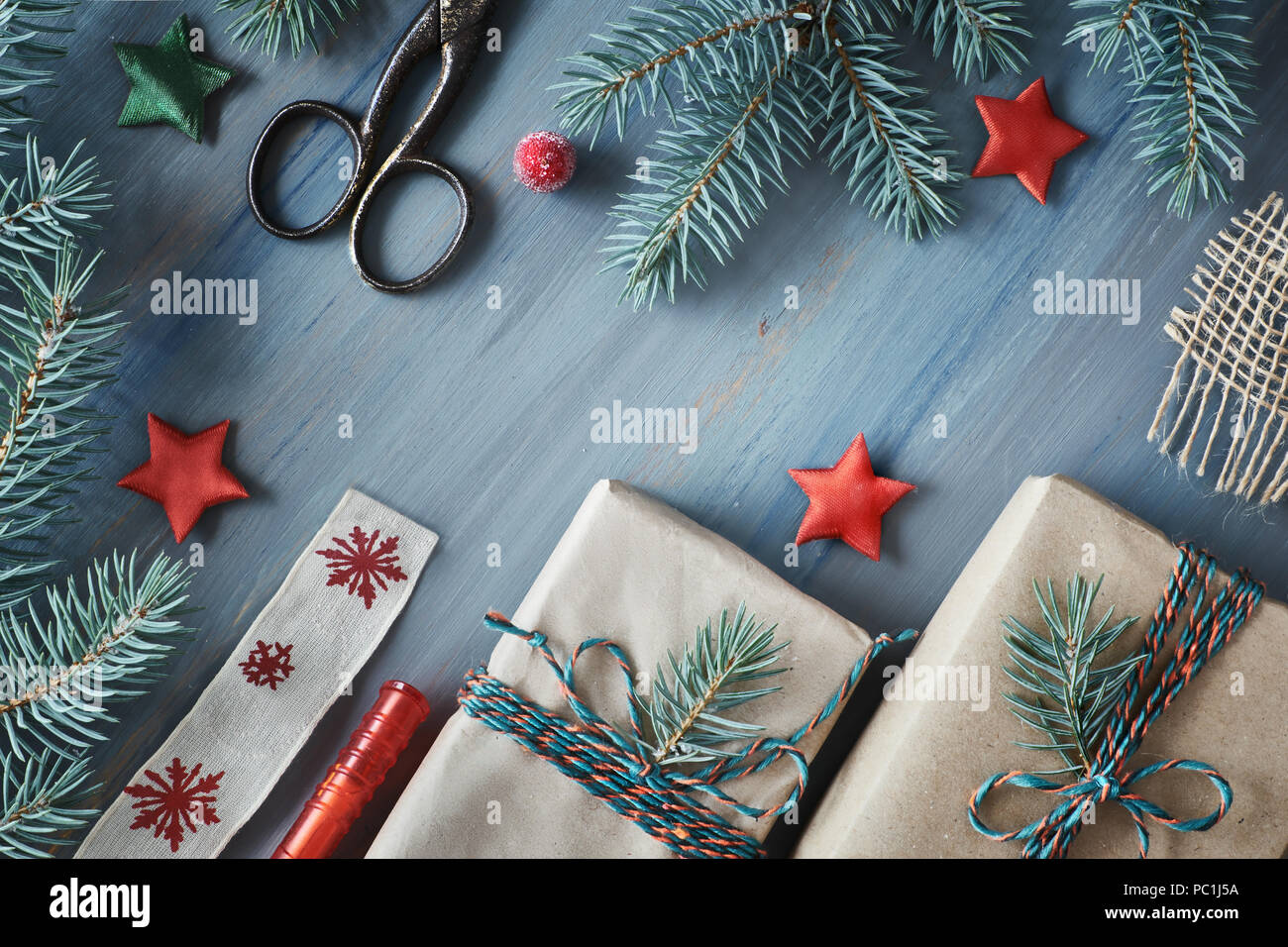 rustic wooden background in green and red with fir branches and christmas gifts in simple brown wrapping paper seasonal background shot from above f - Simple Christmas Gifts rustic wooden background in green and red with fir branches and christmas gifts in simple brown wrapping paper seasonal background shot from above f - Simple Christmas Gifts