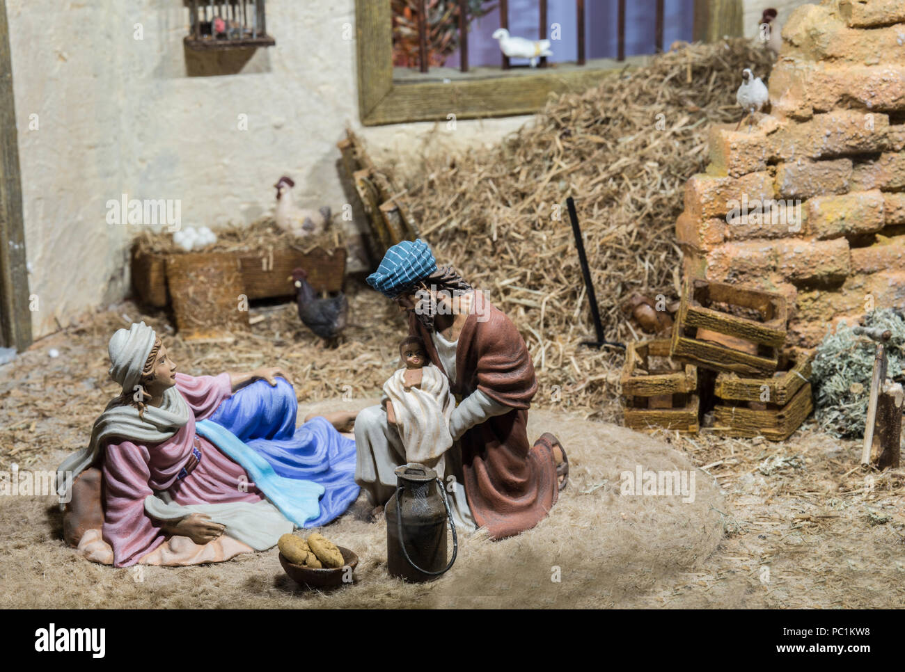 Holy family with the infant jesus in the crib hires stock photography