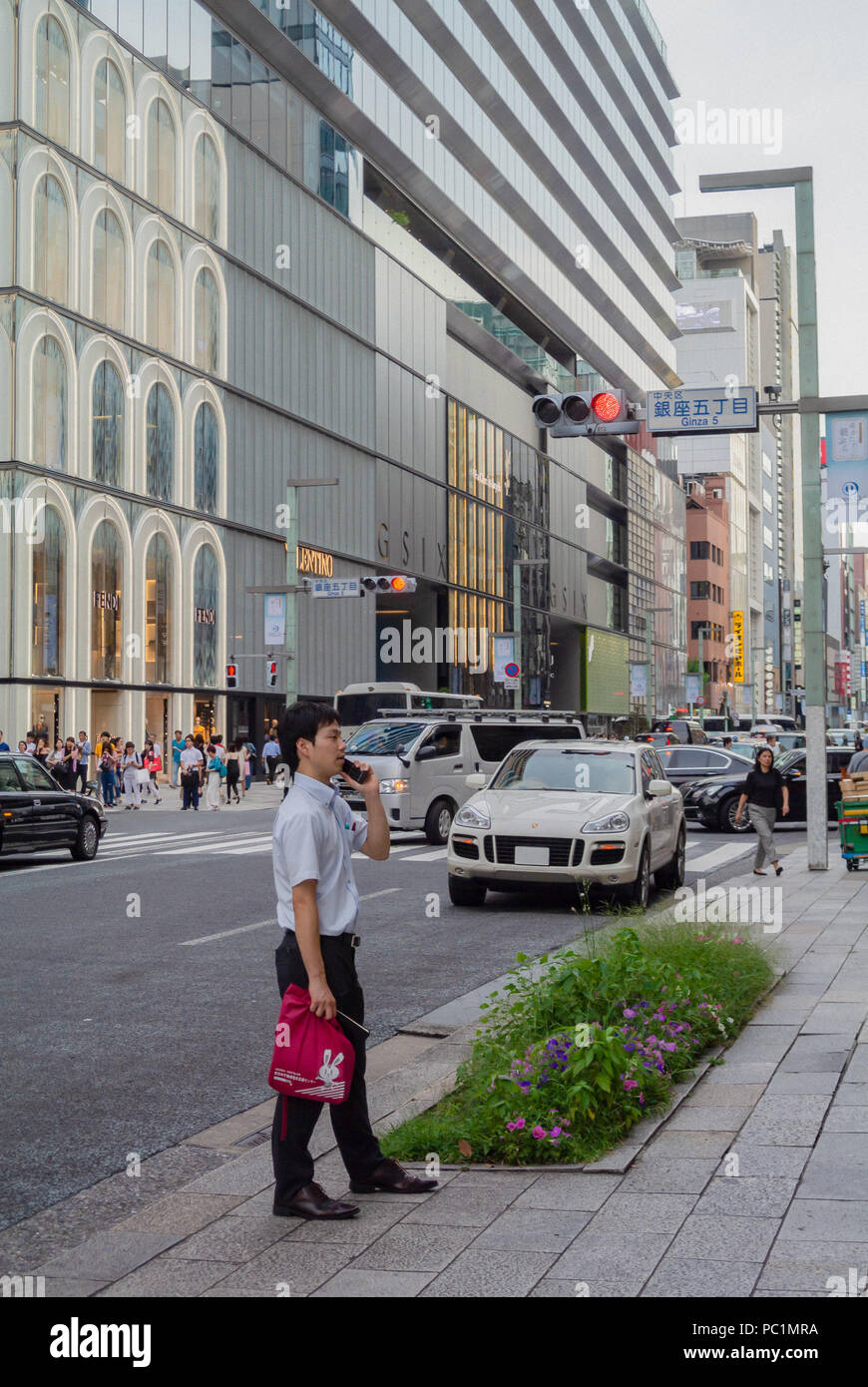 A Japanese business man with mobile in the street, ginza, tokyo, Japan Stock Photo