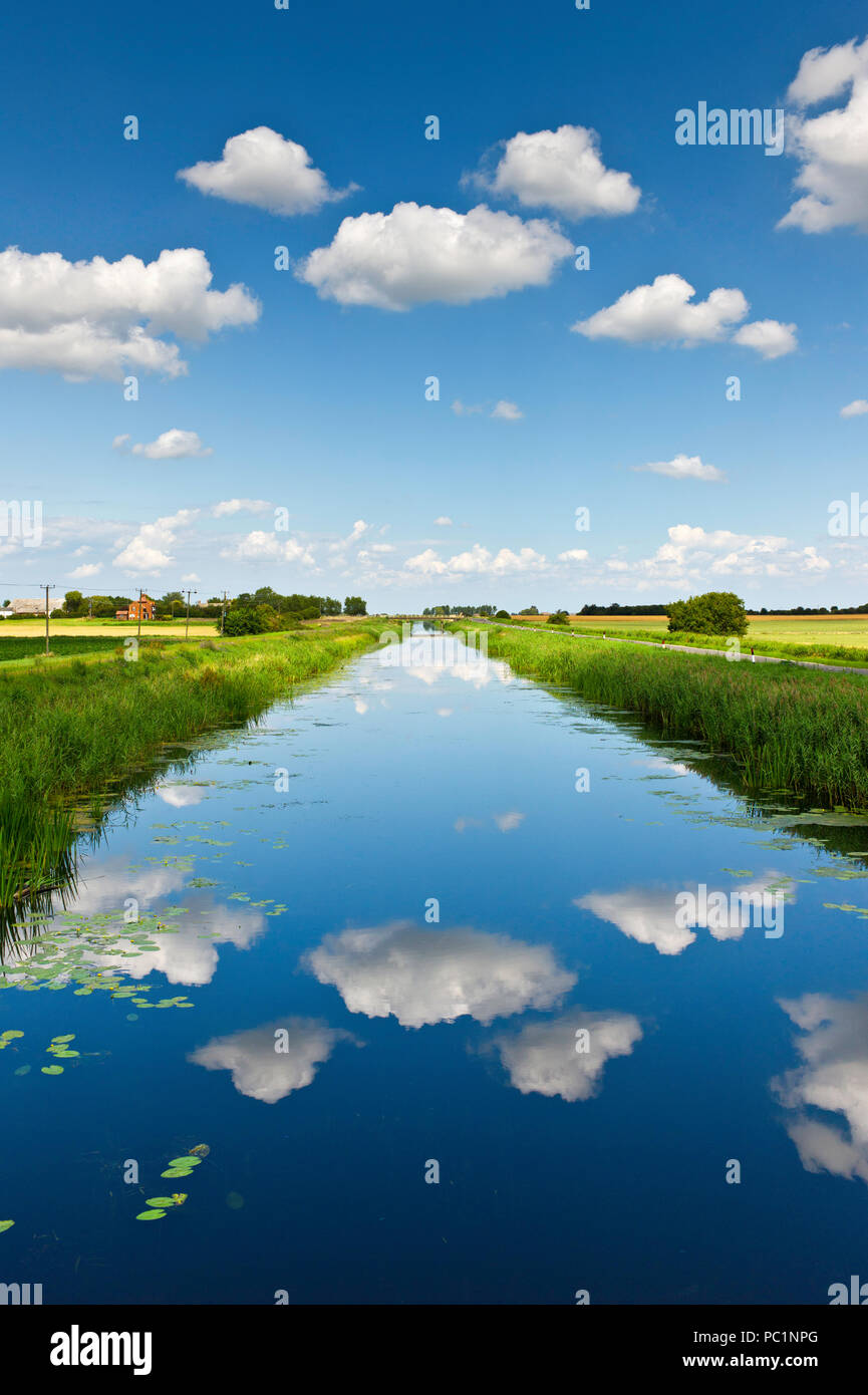 Fluffy white clouds over the sixteen foot drain in Cambridgeshire fenland. Stock Photo