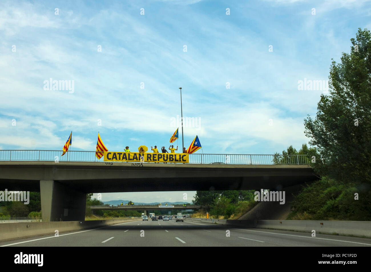 Pro-Catalan independence activists on flyovers used banners and flags to pronounce the Catalan republic and call for the release of political prisoner Stock Photo