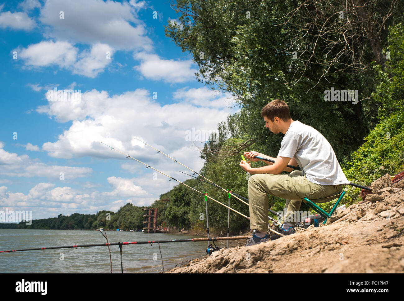Fisherman on the river bank Stock Photo - Alamy