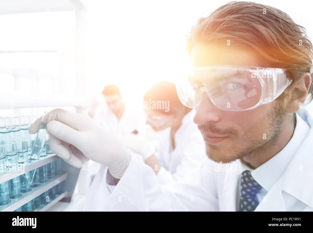 man in goggles to check fluid in vitro. Stock Photo