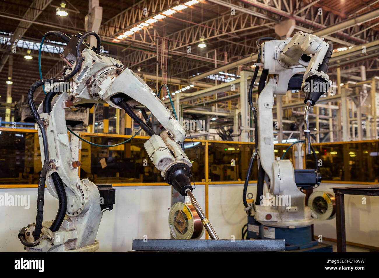 Team robots welding are in teaching mode Stock Photo