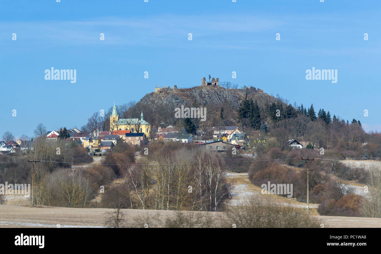 roadside rural scenery including a hill and village in the Czech Republic at winter time Stock Photo