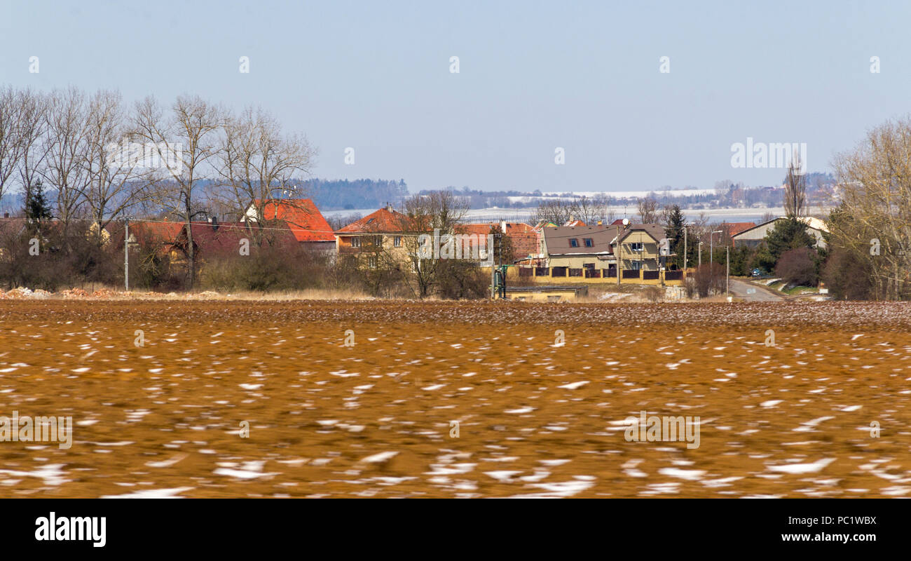 roadside scenery showing a czech village at winter time Stock Photo
