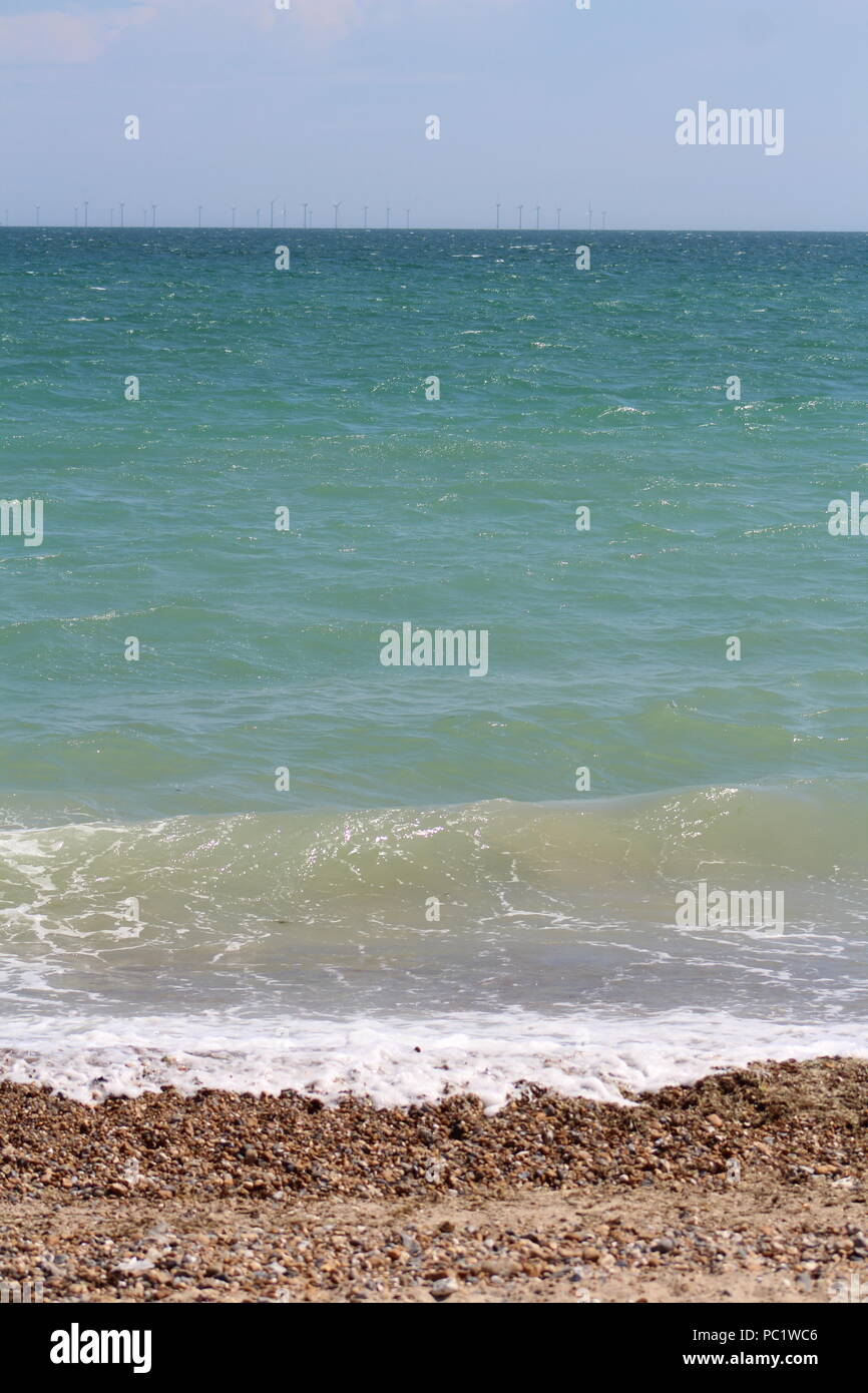 Tide coming in over pebbled beach in Goringbysea Stock Photo Alamy