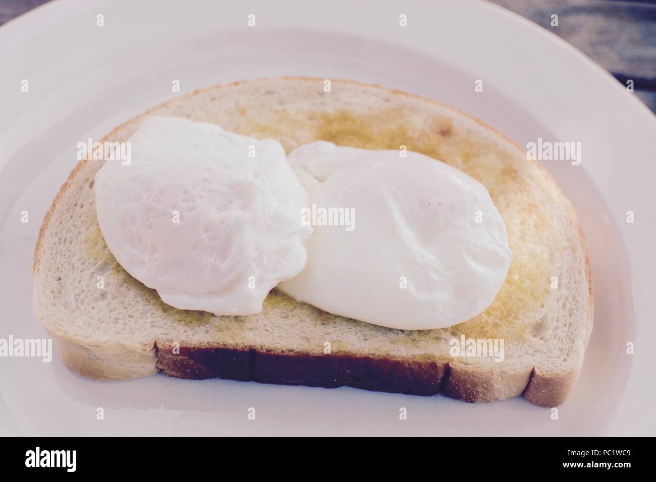 Poached eggs served on white toast Stock Photo