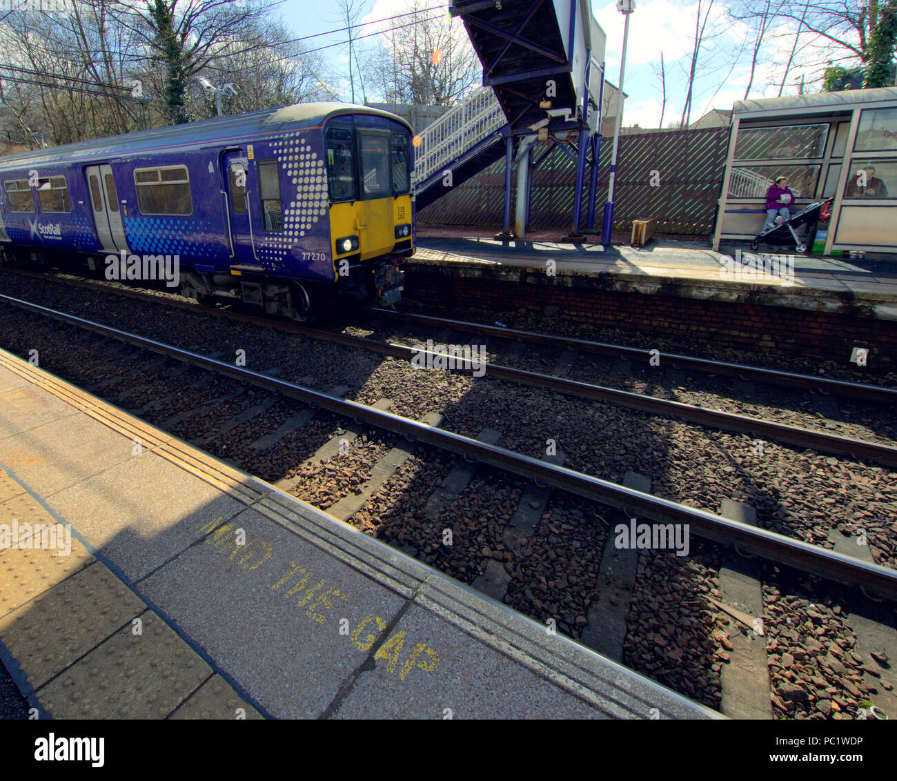 mind the gap train arriving Drumchapel Railway Station in deprived housing  scheme of drumchapel in Glasgow Stock Photo