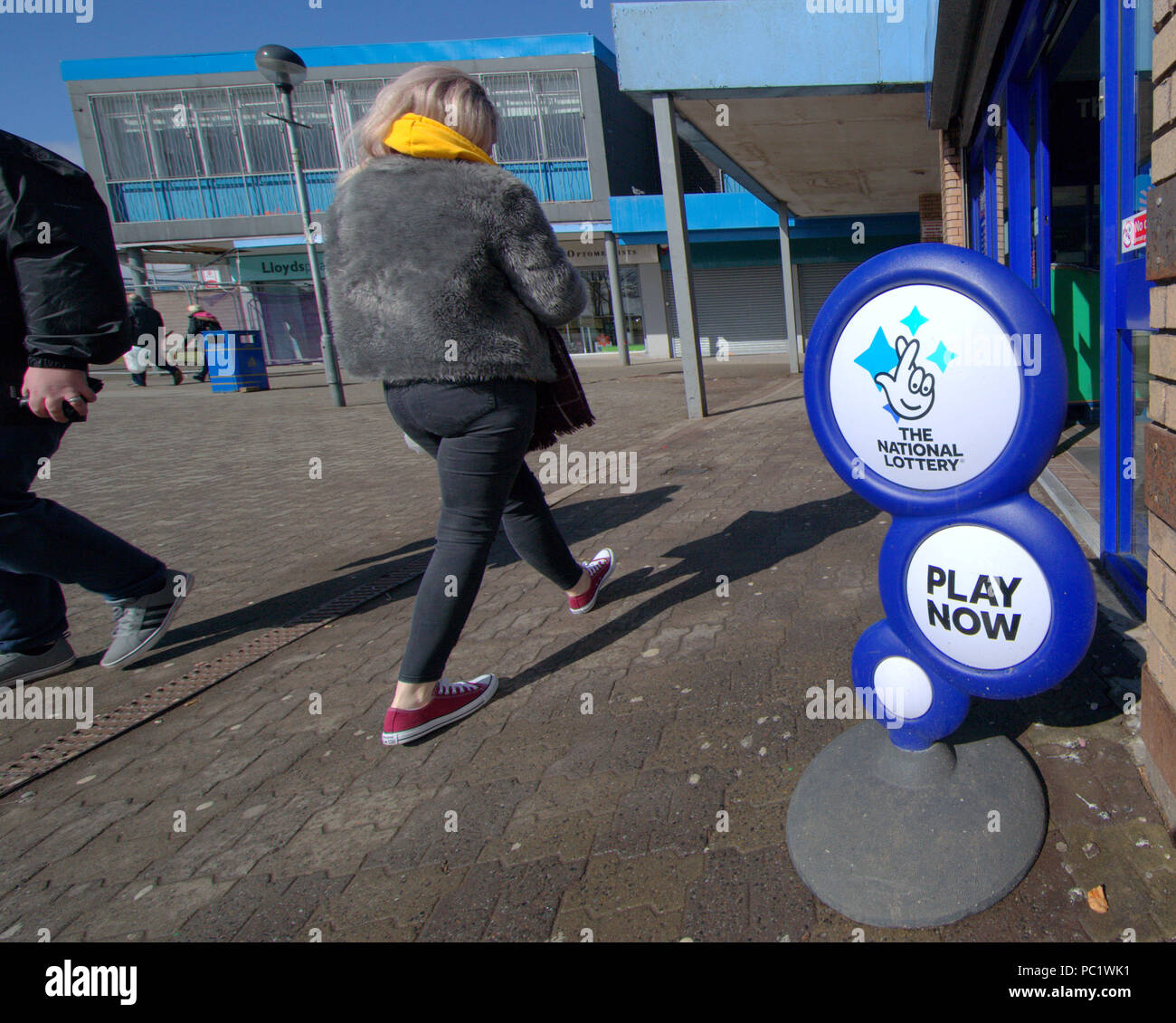 the national lottery play now sign display in deprived area shopping centre Stock Photo