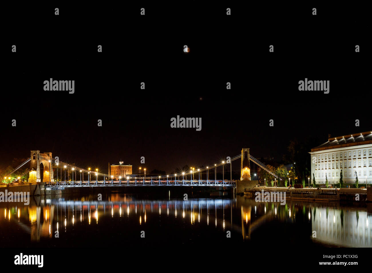 Total lunar eclipse and the Grunwald Bridge. Wrocław, Poland. Stock Photo