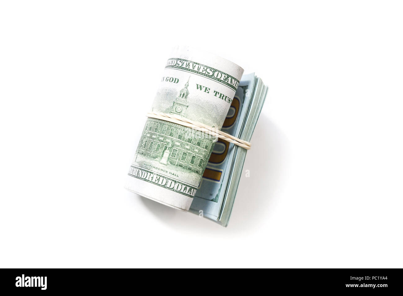 USA currency, roll of One Hundred Dollars lays on white background with soft shadow Stock Photo