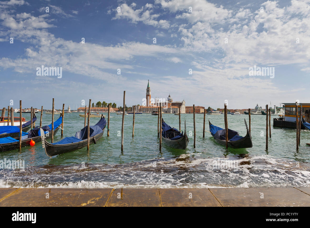 Moored gondolas, with view of Church of San Giorgio Maggiore, Venice Stock Photo
