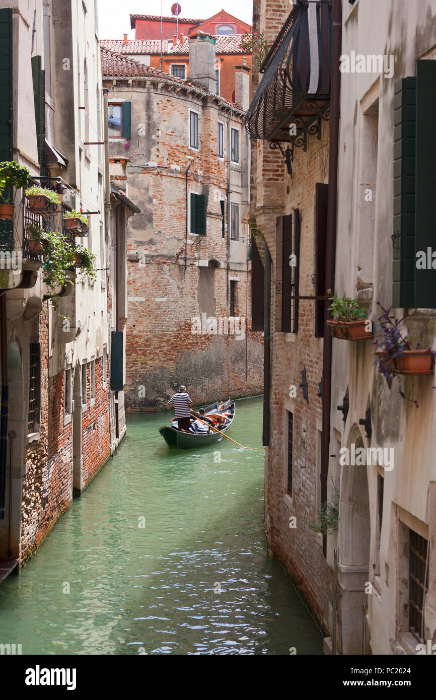 Tourists in gondola, Venice Stock Photo