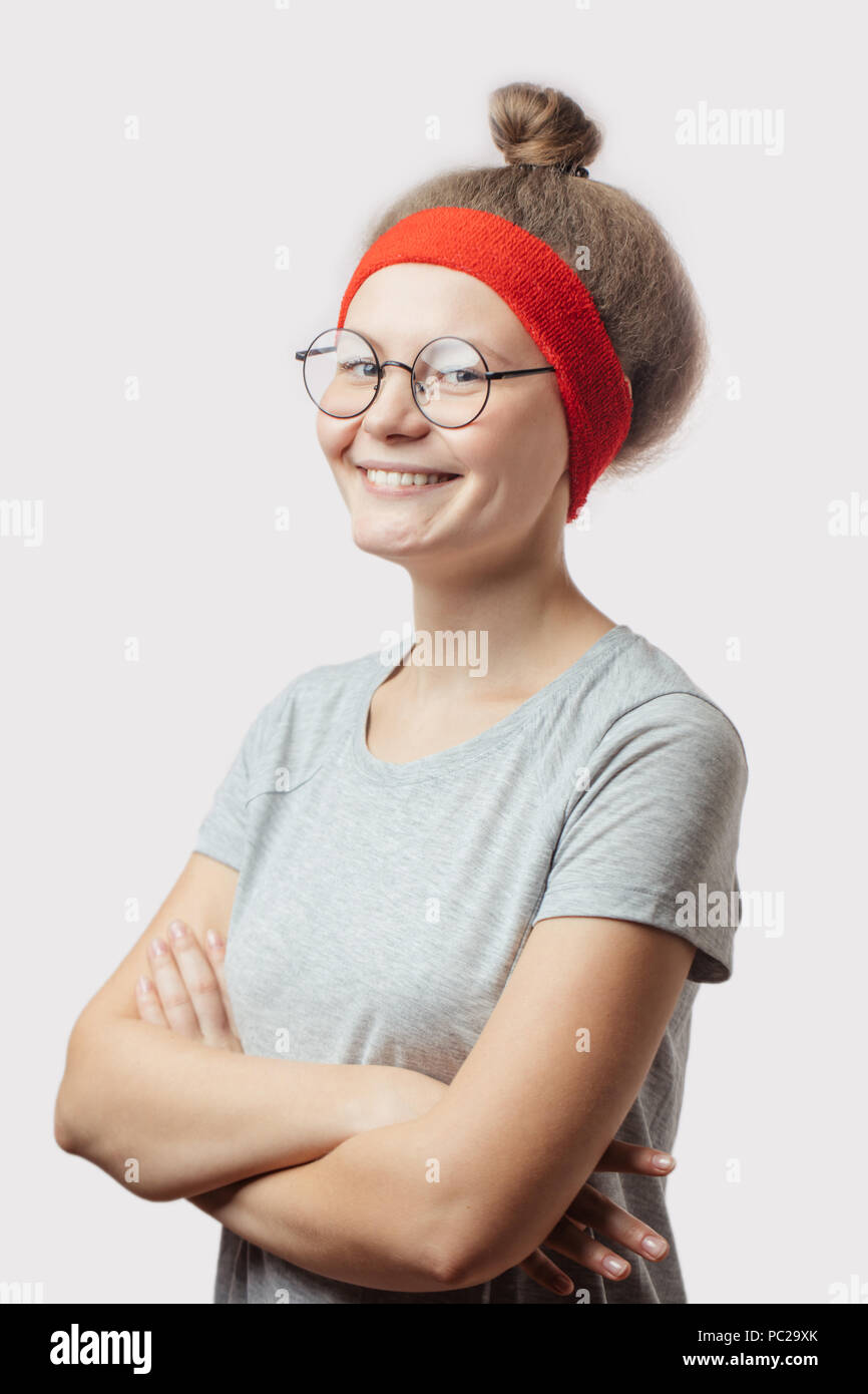 cheerful girl with nappy head standing with crossed arms. close up side view photo Stock Photo