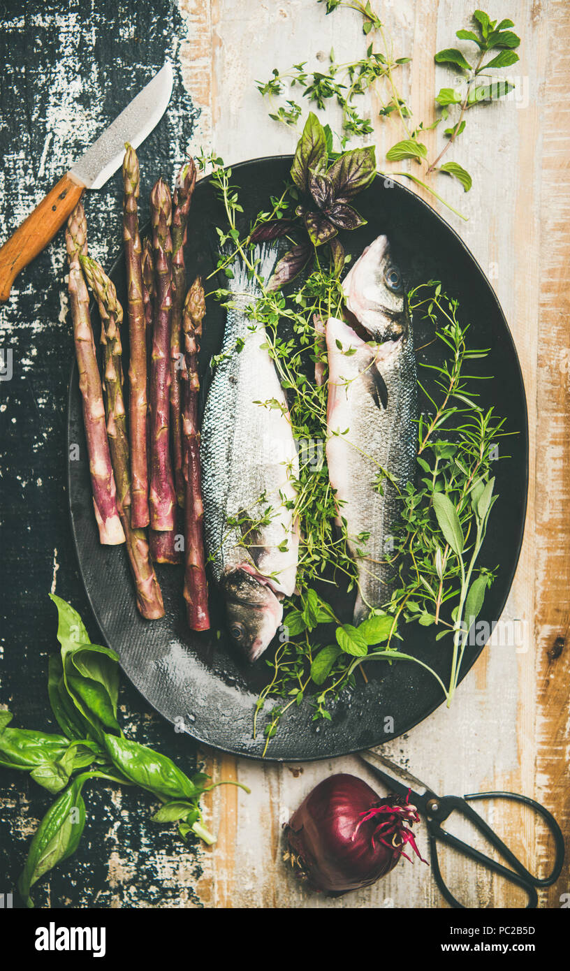 Raw uncooked sea bass fish with herbs and asparagus Stock Photo Alamy