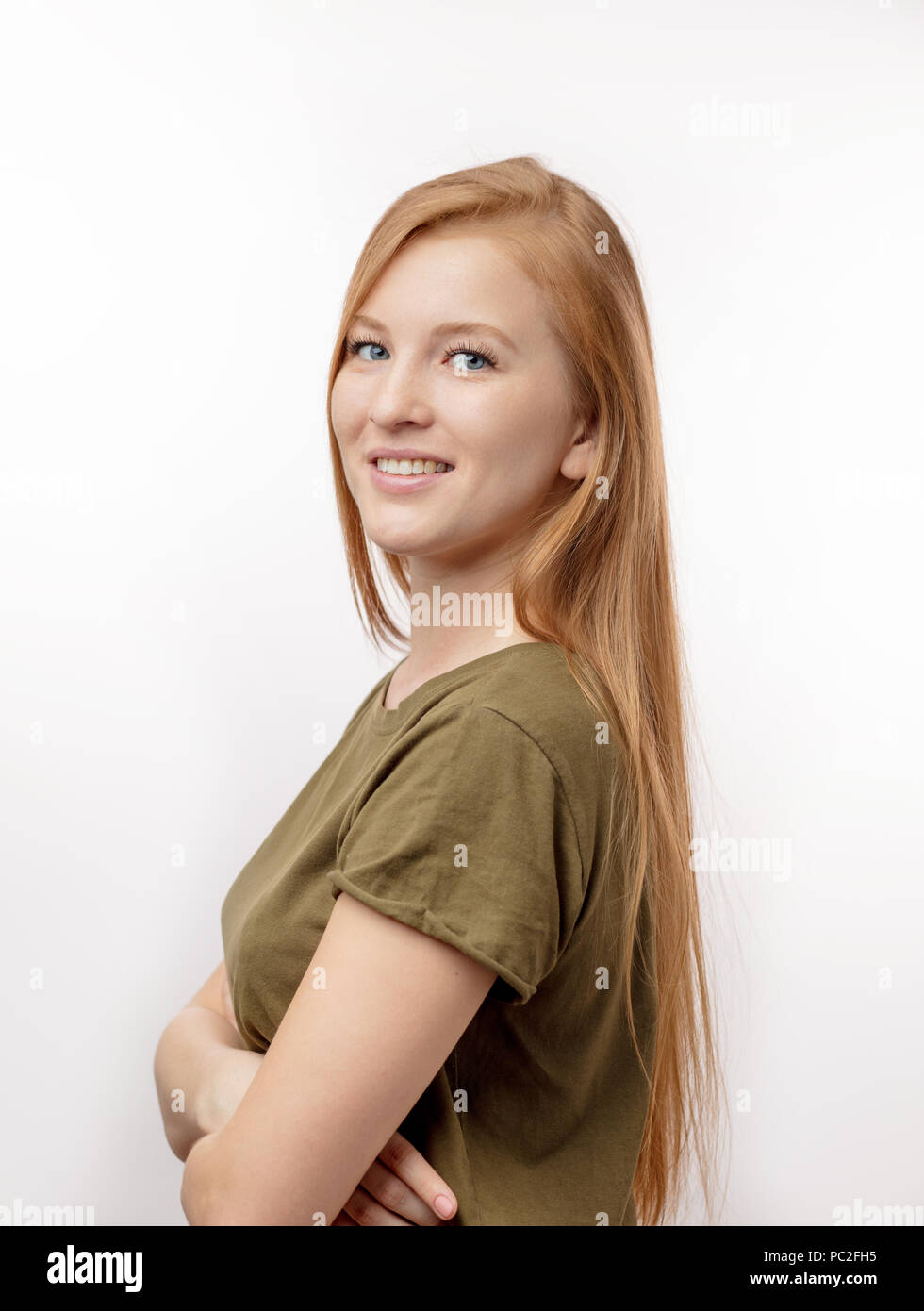 ginger female with blue eyes posing to the camera. isolated white ...