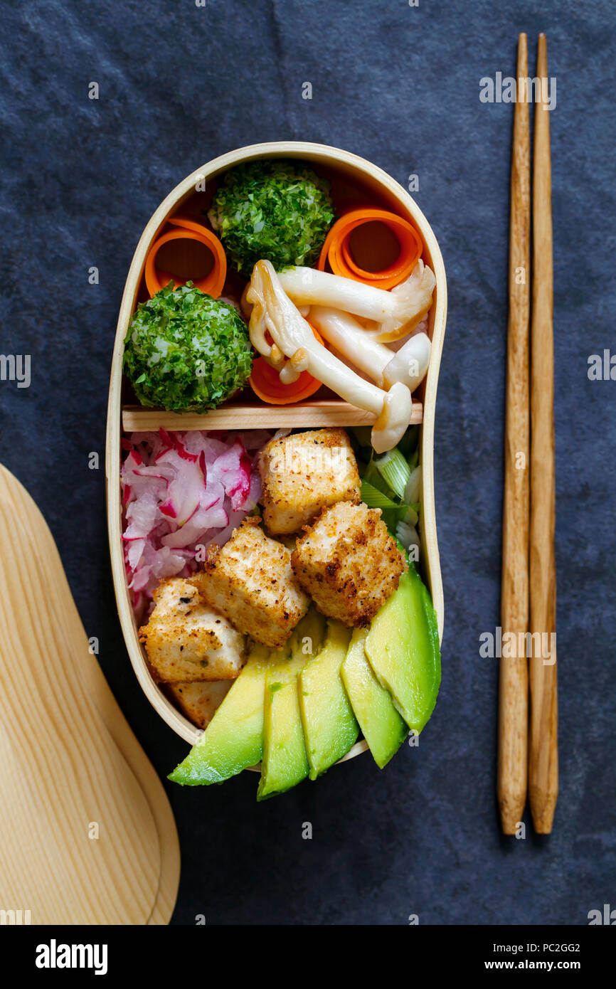 Japanese bento box lunch withg mushrooms, onigiri and tofu Stock Photo