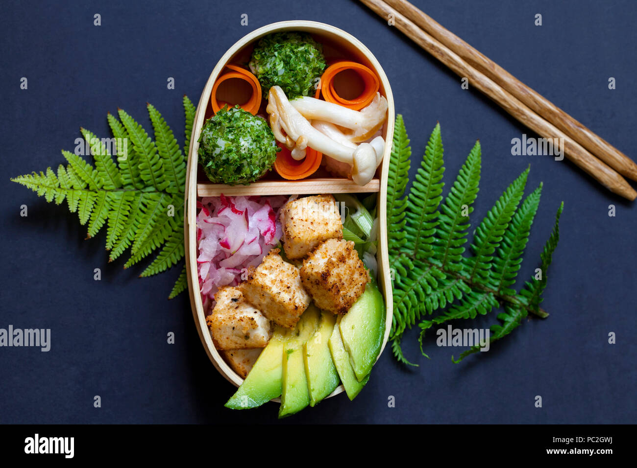 Japanese bento box lunch withg mushrooms, onigiri and tofu Stock Photo