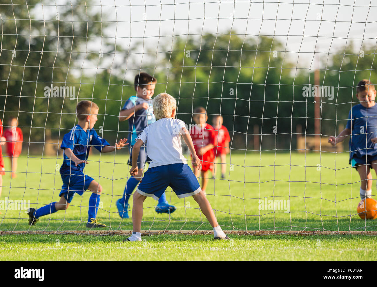 Young boys play football match Stock Photo Alamy