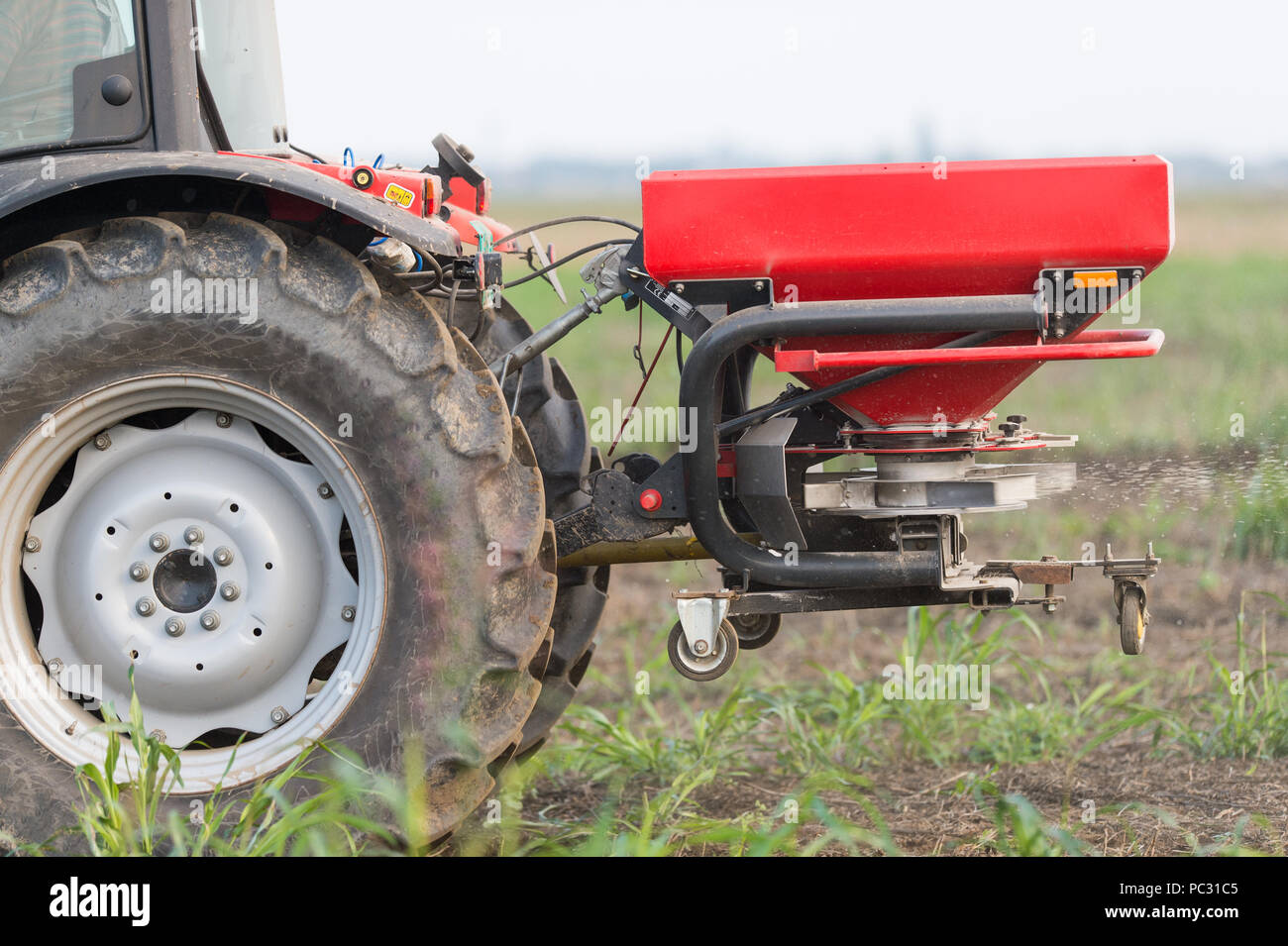 Tractor and fertilizer spreader in field Stock Photo Alamy